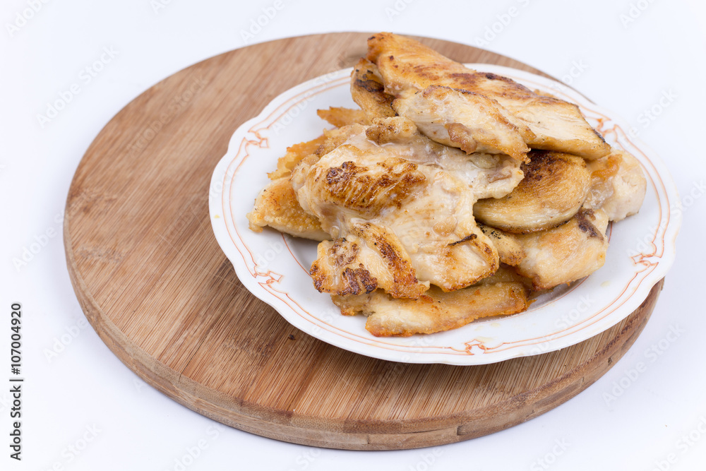 Grilled chicken breasts on the plate isolated over white