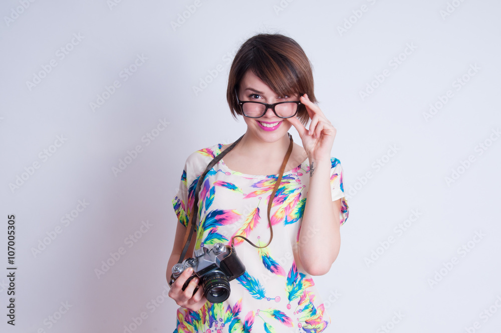 Woman photographer with camera against gray background Woman photographer with camera against gray background