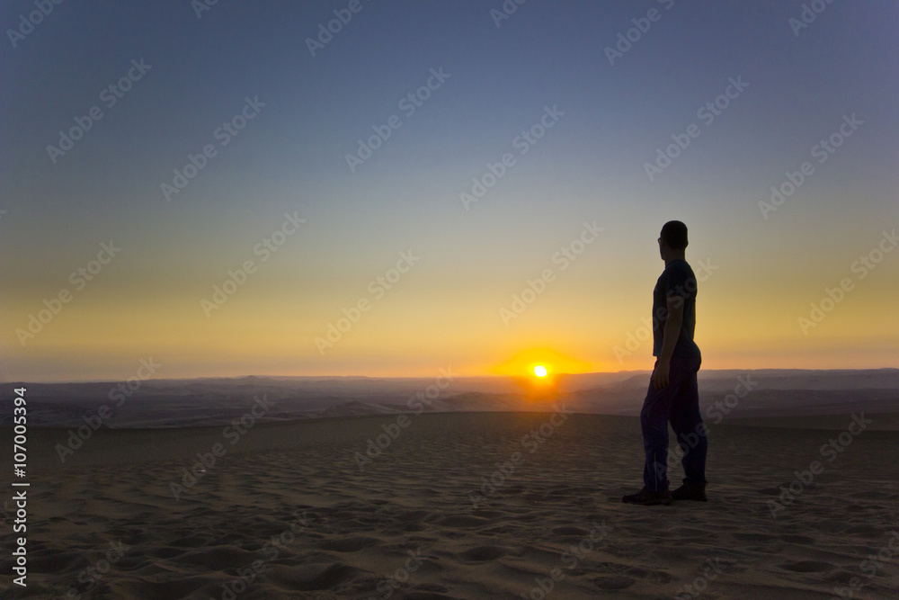 standing man at sunset in desert