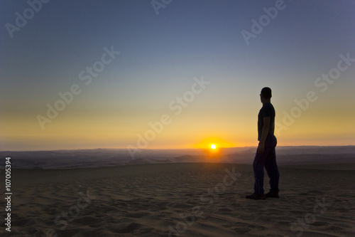 standing man at sunset in desert