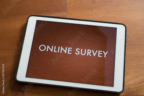 tablet on table with online customer survey