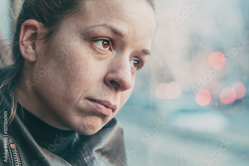 A woman in streetcar alone and depressed
