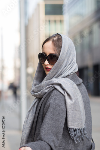 Attractive brunette in grey shawl outdoors, springtime © tafiphoto