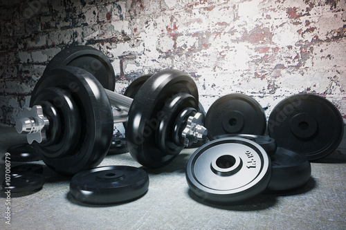 Dumbbell and plates on floor