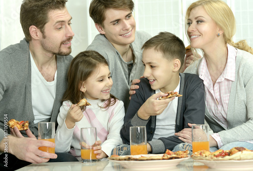 family at home with pizza