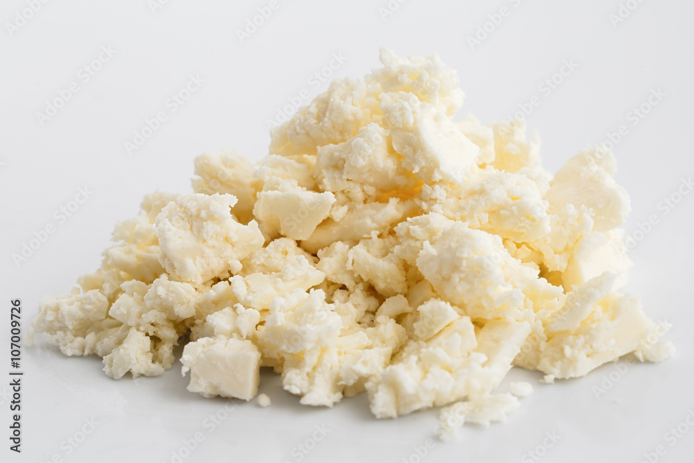 Crumbled white feta cheese isolated on white.
