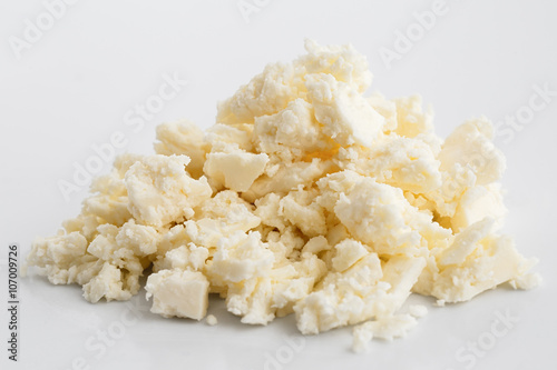 Crumbled white feta cheese isolated on white.