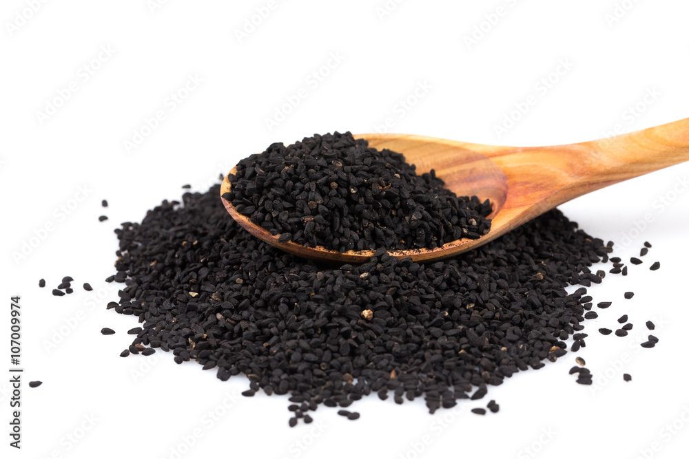 Heap of black sesame on wooden spoon Heap of black sesame on wooden spoon