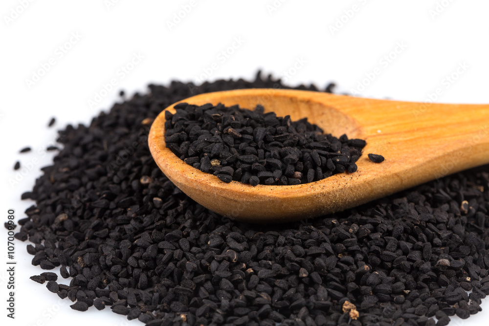 Heap of black sesame on wooden spoon Heap of black sesame on wooden spoon