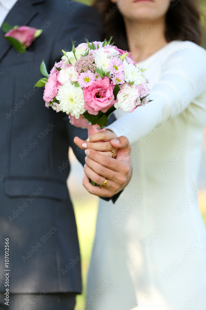 Bride and groom holding wedding bouquet Bride and groom holding wedding bouquet