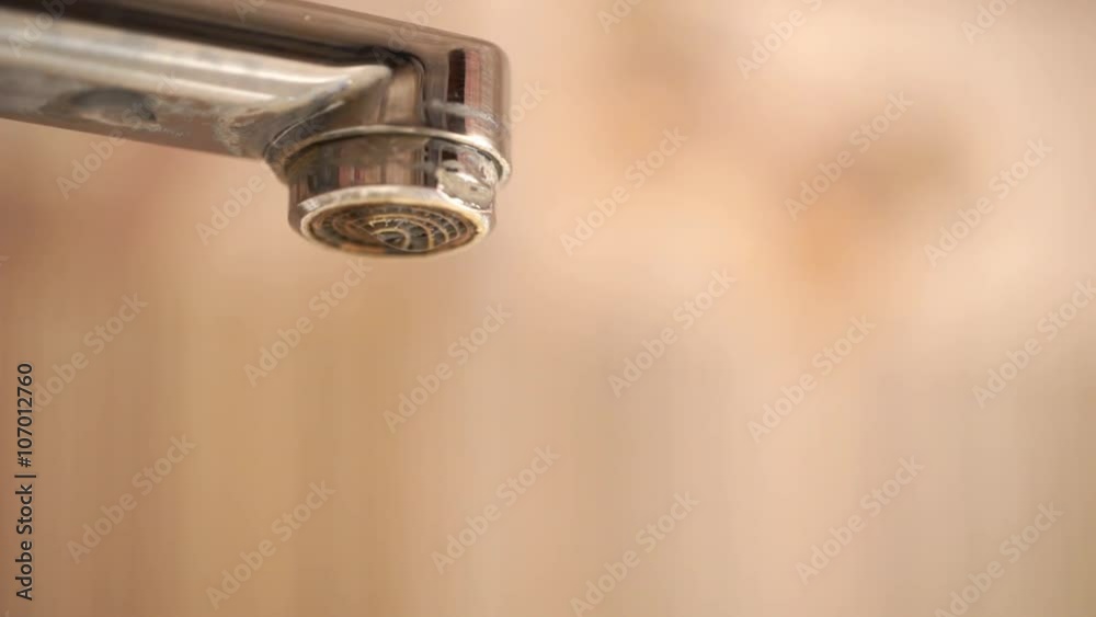Chrome shiny faucet with running water slows to a drip Chrome shiny faucet with running water slows to a drip