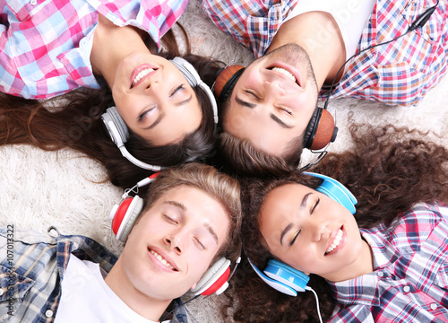Two teenager couples listen...