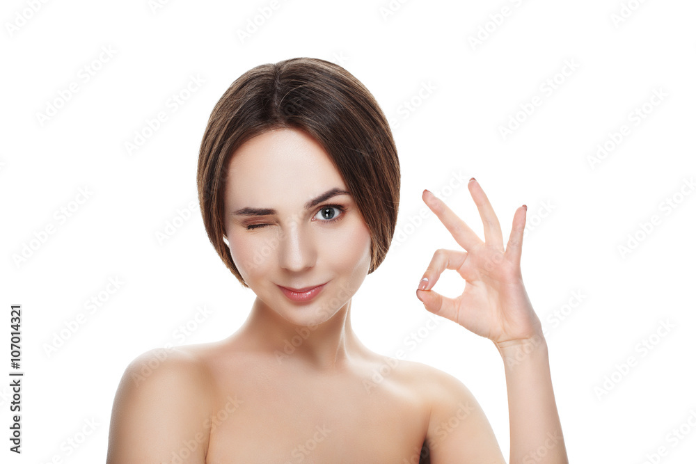 Pretty girl with natural makeup show gesture OKEY. Beautiful spa woman touching her face. Perfect fresh skin. Pure beauty model girl. Youth and skin care concept Pretty girl with natural makeup show gesture OKEY. Beautiful spa woman touching her face. Perfect fresh skin. Pure beauty model girl. Youth and skin care concept
