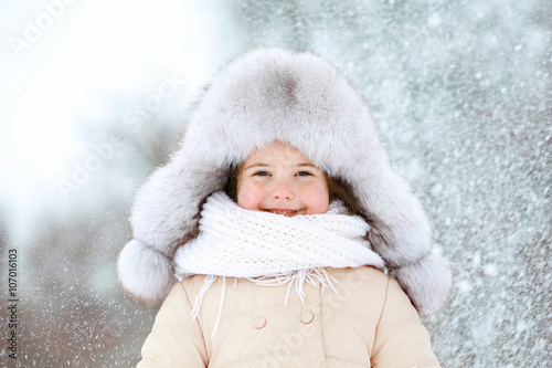Little girl with fur hat in...