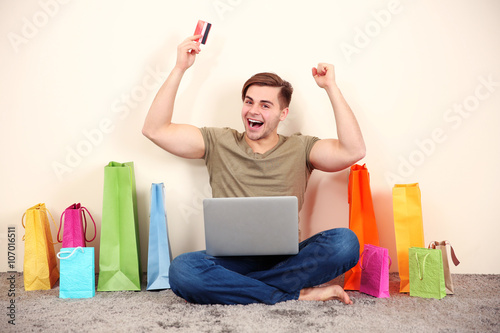 Young man doing online shop...