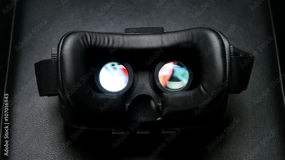 Male hand taking a virtual reality headset.
Male hand taking a virtual reality headset.