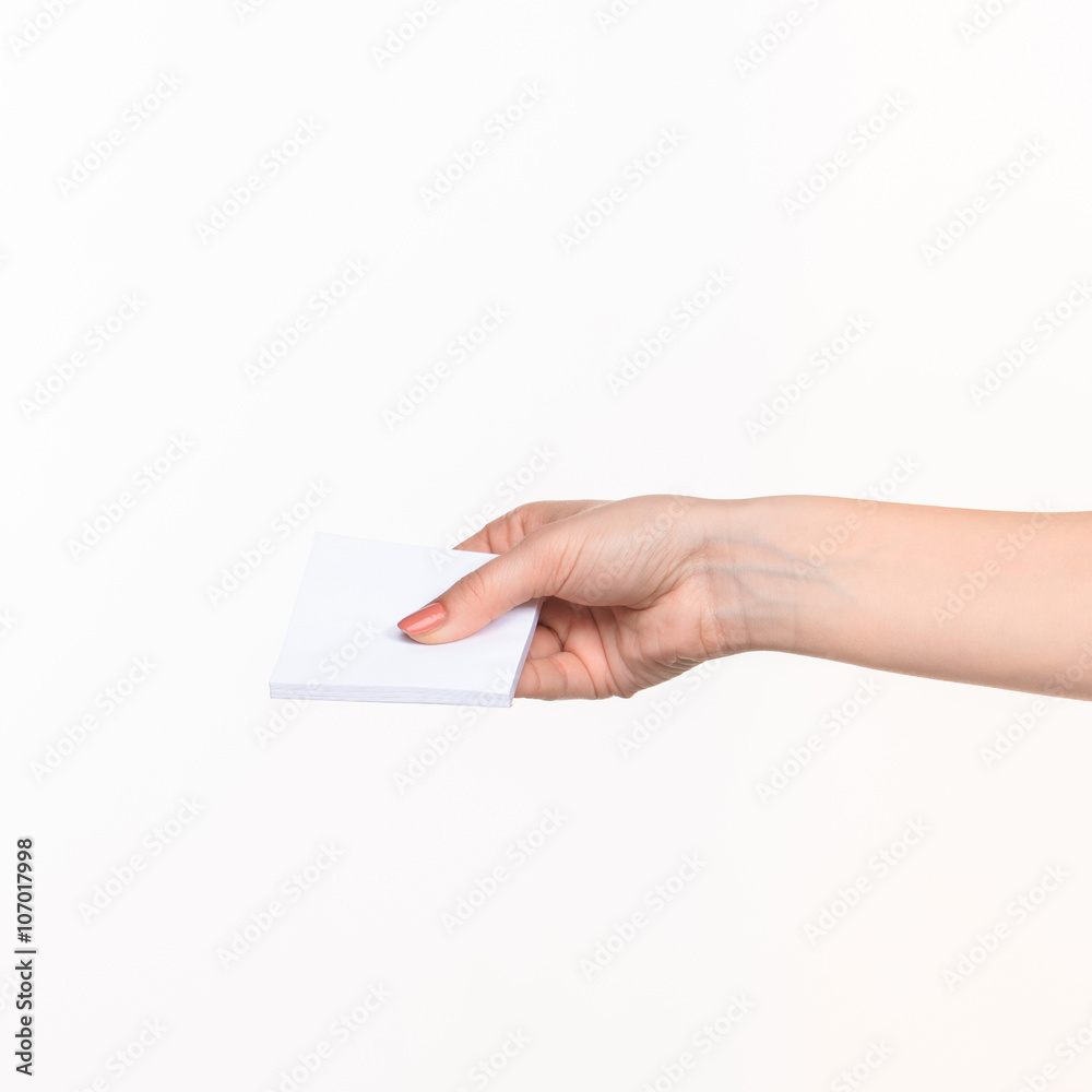 Female hand holding blank paper for records on white. Female hand holding blank paper for records on white.
