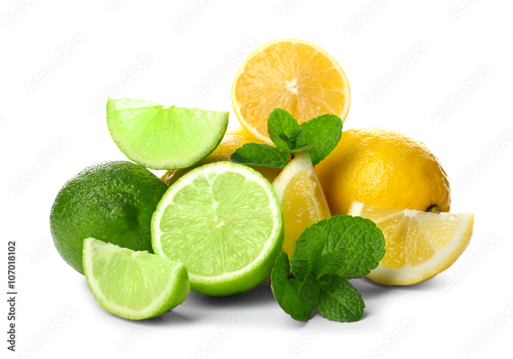 Ripe lime and lemon with slices and green leaves isolated on white Ripe lime and lemon with slices and green leaves isolated on white
