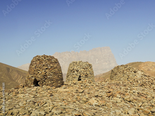 Lined up dramatically atop a rocky ridge, the Beehive Tombs of B photo