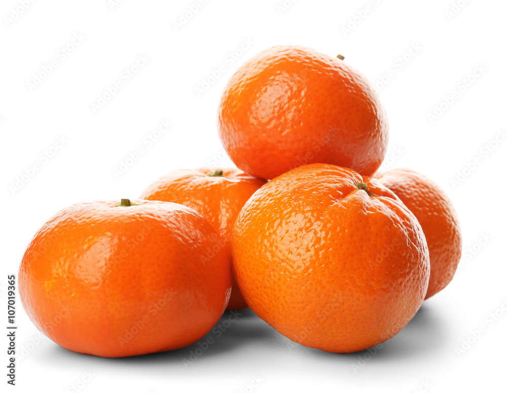 A pile of fresh tangerines isolated on white background, close up A pile of fresh tangerines isolated on white background, close up