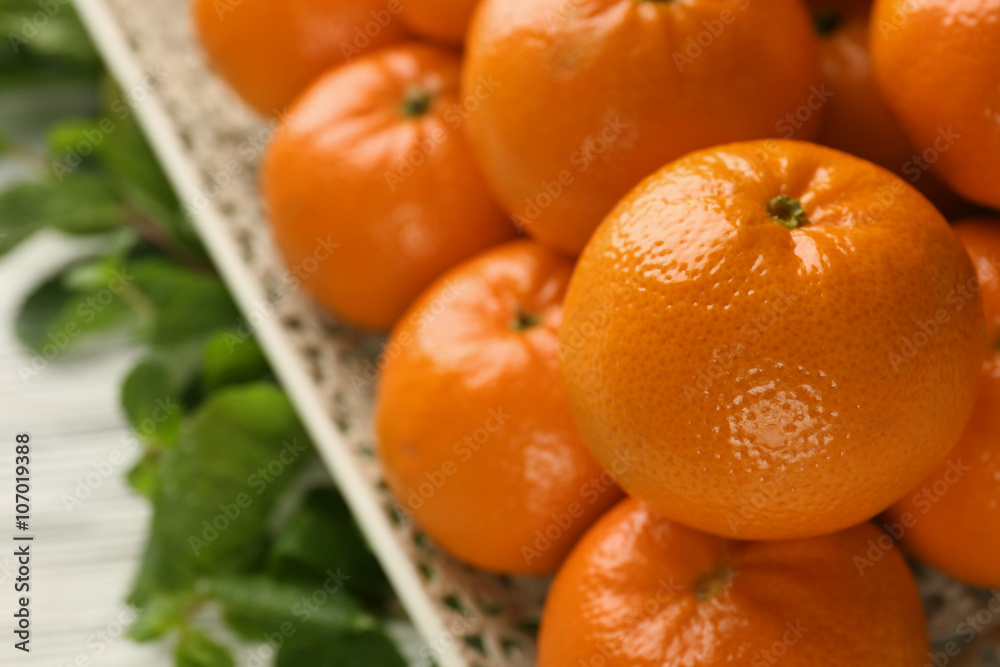 Fresh, delicious tangerines on the white wooden table, close up