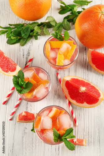 Ripe grapefruits and fresh juice with mint  close up