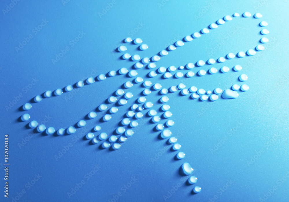 Dragonfly made of water drops on blue background