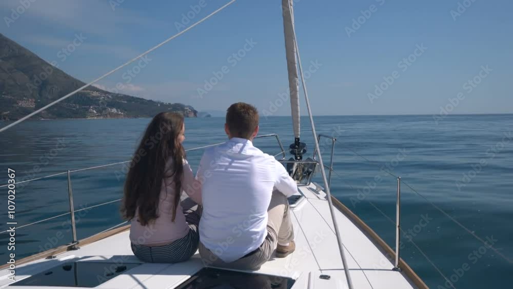 enamored couple sitting on a yacht enamored couple sitting on a yacht