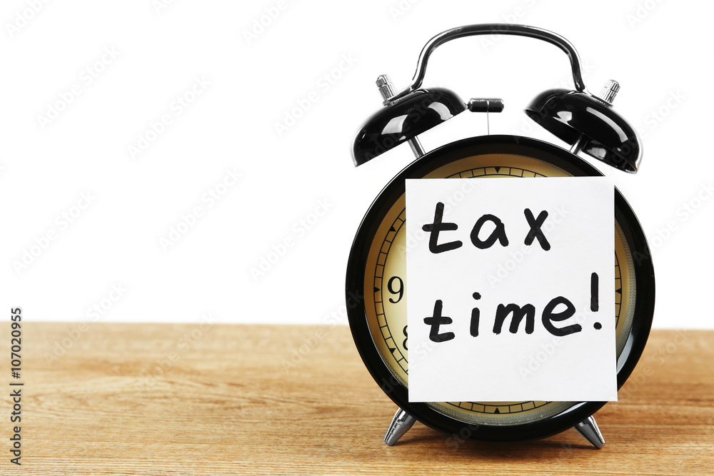 Tax time on alarm clock on table