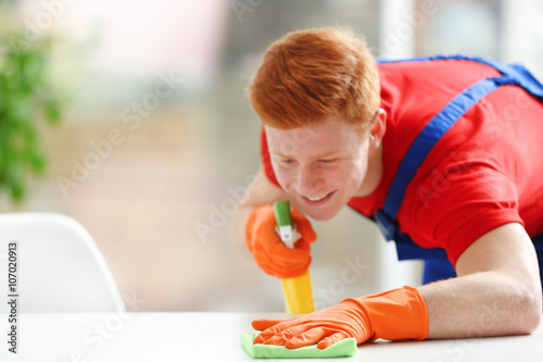 Young janitor with liquid d...