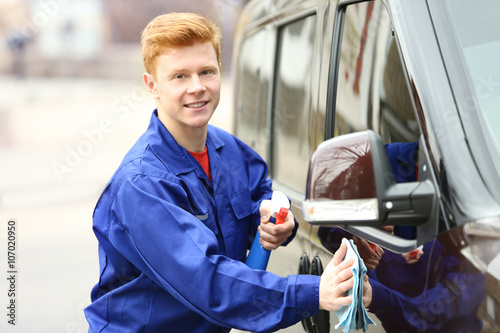 Young man polishing car