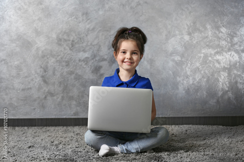 Little girl with laptop on ...