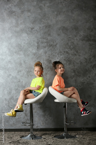 Two stylish little girls on...