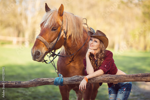 Horse and girl with cowboy hat © Buyanskyy Production