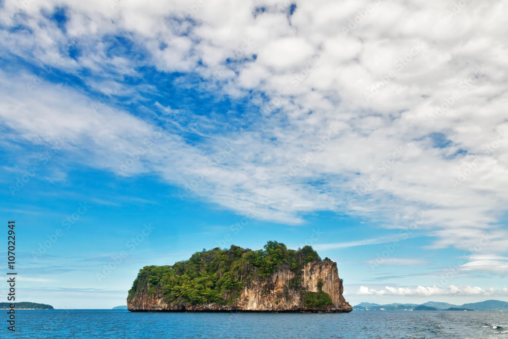 Exotic tropical island under blue sky.