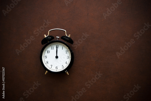Vintage alarm clock on noon midnight hour photo
