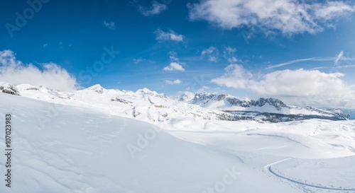 Fototapeta Naklejka Na Ścianę i Meble -  Winter panorama with snow covered slopes and dramatic sky.