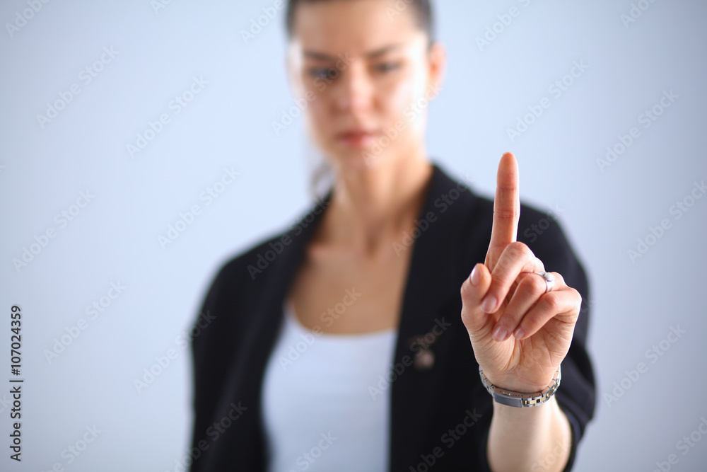 Woman touching an imaginary screen with her finger Woman touching an imaginary screen with her finger