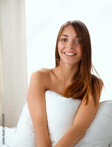 Portrait of beautiful woman on bed at bedroom