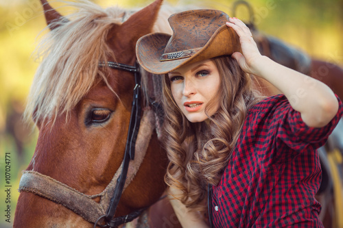 Horse and fashion model with cowboy hat