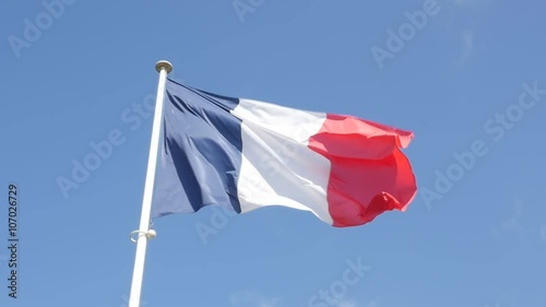 Slow motion of famous French flag fabric waving in front of blue sky 1920X1080 FullHD footage - Tricolor flag of France slow-mo flowing by the day 1080p HD video 