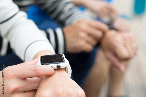 Group of people using smartwatch together