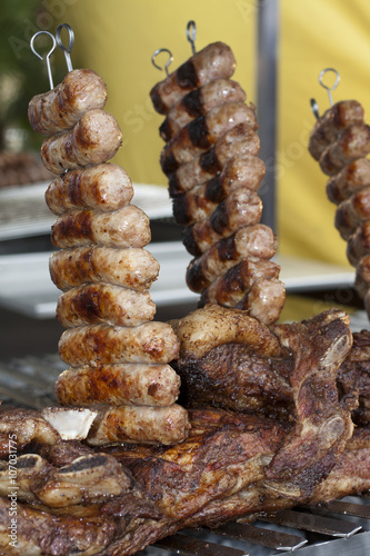 typical argentine meal cooked on grill with skewer