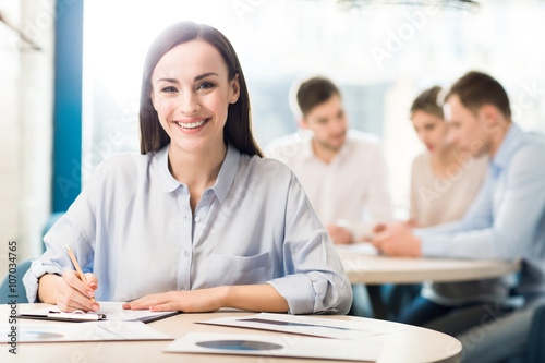 Positive woman sitting at the table