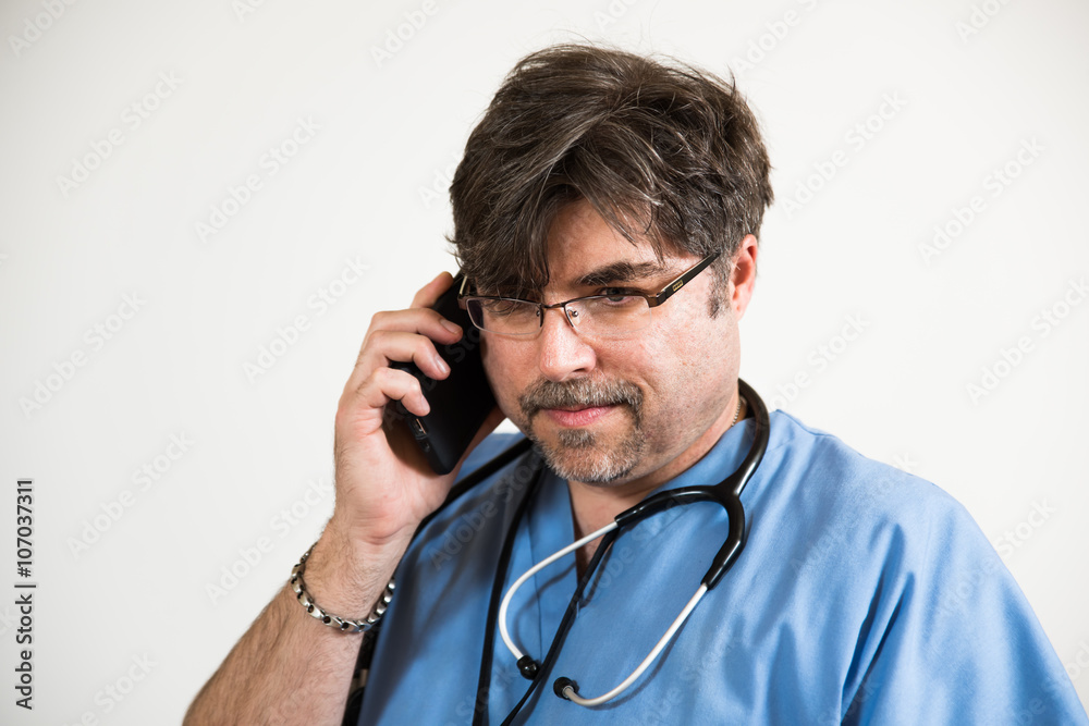 Doctor looking down, talking on generic cell phone. Doctor looking down, talking on generic cell phone.