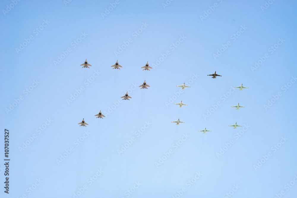 Fototapeta premium Number 70 made by 7 Mig-29 and 8 Su-25 on blue sky background 