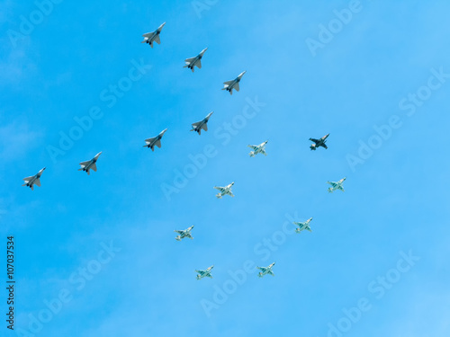 Number 70 made by 7 Mig-29 and 8 Su-25 on blue sky background 