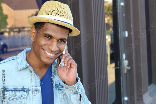 Outdoor portrait of modern young man with mobile phone with copy space on the right side photo