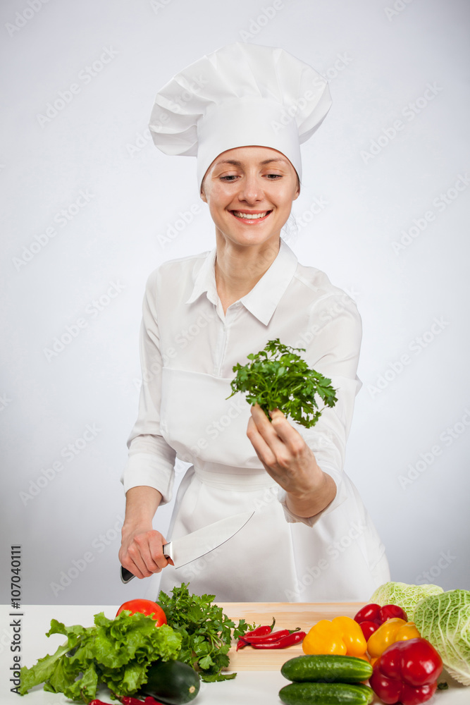 Happy young female cook holding fresh parsley for vegetable salad Happy young female cook holding fresh parsley for vegetable salad