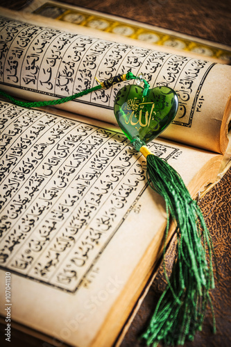 Muhammad prophet of Islam written on glass heart with Quran photo